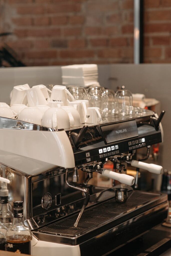 Mastering the First Impression: Your intriguing post title goes here Close-up of a professional espresso machine with cups in a modern cafe setting.